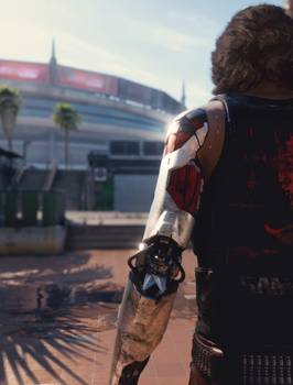 Johnny Silverhand walking in Cyberpunk 2077. We can see the back of him. He has long hair and an artificial metal arm. 